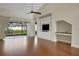 Living room featuring vaulted ceiling, hardwood floors, and built in shelving at 2987 Mission Lakes Dr # 10, Lakeland, FL 33803