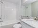 Bathroom featuring shower over tub, white subway tile, and a granite-topped vanity at 300 Senate St, Auburndale, FL 33823