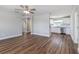 Bright living room with hardwood floors flowing into an updated kitchen with stainless appliances at 300 Senate St, Auburndale, FL 33823