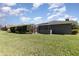 Wide shot of the expansive backyard with an enclosed pool and patio at 3001 Plantation Rd, Winter Haven, FL 33884