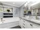 Bathroom featuring dual sinks, granite counters, soaking tub, and decorative accents at 3001 Plantation Rd, Winter Haven, FL 33884