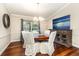 This dining room has wood floors, a light fixture and large windows for natural light at 3001 Plantation Rd, Winter Haven, FL 33884