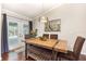 Cozy dining area features modern farmhouse table with bench seating and French doors to the pool area at 3001 Plantation Rd, Winter Haven, FL 33884