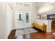 Bright foyer features hardwood floors, decorative double doors, and a stylish yellow bench at 3001 Plantation Rd, Winter Haven, FL 33884