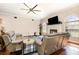 Living room with hardwood floors, fireplace, ceiling fan, and lots of natural light from the surrounding windows at 3001 Plantation Rd, Winter Haven, FL 33884