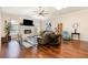 Spacious living room featuring wood floors, fireplace, skylight, and lots of natural light at 3001 Plantation Rd, Winter Haven, FL 33884