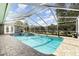 Screened-in pool area with blue water, brick pavers, and lush landscaping at 3001 Plantation Rd, Winter Haven, FL 33884