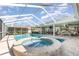 Full view of the pool, spa, and covered lanai area on a sunny day at 3001 Plantation Rd, Winter Haven, FL 33884