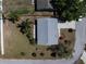 Top-down aerial view of a well-maintained property featuring a gray roof, landscaping, and a paved driveway in a quiet neighborhood at 3166 Valley Vista Cir, Lakeland, FL 33812