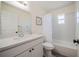 Bathroom features white vanity with a white sink, framed mirror, and a shower-tub combo at 3166 Valley Vista Cir, Lakeland, FL 33812