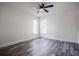 Light-filled bedroom with wood-look flooring, neutral walls, and natural light from two windows at 3166 Valley Vista Cir, Lakeland, FL 33812