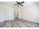 Bedroom featuring wood-look flooring, ceiling fan, and ample closet space at 3166 Valley Vista Cir, Lakeland, FL 33812