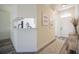 Bright entryway with a view of the kitchen, featuring modern flooring, neutral walls, and stylish decor at 3166 Valley Vista Cir, Lakeland, FL 33812