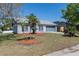 Charming home featuring a manicured lawn, mature trees, and an attached two-car garage, presenting a welcoming curb appeal at 3166 Valley Vista Cir, Lakeland, FL 33812