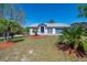 Inviting single-story home showcasing a well-maintained lawn, palm trees, colorful mulch, and a cozy, residential atmosphere at 3166 Valley Vista Cir, Lakeland, FL 33812