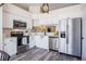 Modern kitchen featuring stainless steel appliances, white cabinetry, quartz countertops, and stylish fixtures for a contemporary feel at 3166 Valley Vista Cir, Lakeland, FL 33812