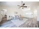 Open living area with wood-look flooring, light grey sofa, and stylish accents at 3166 Valley Vista Cir, Lakeland, FL 33812