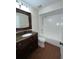 Bathroom featuring dark wooden cabinets and a shower-tub combination at 3626 Amber Ln, Lakeland, FL 33812