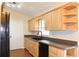 Bright kitchen featuring wood cabinets, a modern sink, and sleek black appliances at 3626 Amber Ln, Lakeland, FL 33812