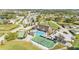 Panoramic aerial view of the community, highlighting the clubhouse, pool, tennis courts, and meticulously maintained landscaping at 3717 Highland Fairways Blvd, Lakeland, FL 33810