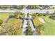 Aerial view of the community entrance with manicured landscaping, a gatehouse, and golf course features, creating a welcoming ambiance at 3717 Highland Fairways Blvd, Lakeland, FL 33810