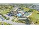 Aerial view of the community clubhouse with a pool, tennis courts, and beautiful landscaping, perfect for recreation at 3717 Highland Fairways Blvd, Lakeland, FL 33810