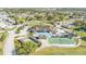 Aerial view showcasing the community clubhouse, pool, tennis courts, parking and lush green landscaping at 3717 Highland Fairways Blvd, Lakeland, FL 33810