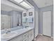 Bathroom featuring double sinks and large mirror at 3717 Highland Fairways Blvd, Lakeland, FL 33810