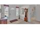 Bright foyer with tiled floors, antique clock, and views into the bathroom at 3717 Highland Fairways Blvd, Lakeland, FL 33810