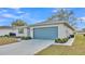 Exterior view of a house with a well-manicured yard, shrubbery, and two car garage at 3717 Highland Fairways Blvd, Lakeland, FL 33810