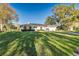 Well-maintained home with green lawn and mature trees enhancing curb appeal on a sunny day at 4120 Old Colony Rd, Mulberry, FL 33860