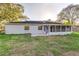 Rear exterior view with a screened patio and fenced-in yard at 4120 Old Colony Rd, Mulberry, FL 33860