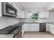 Modern kitchen with white cabinets, stainless steel appliances, and granite countertops at 4120 Old Colony Rd, Mulberry, FL 33860