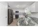 Well-lit kitchen features white cabinetry, granite countertops, and stainless steel appliances at 4120 Old Colony Rd, Mulberry, FL 33860