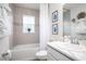 A bathroom with a bathtub, showerhead, vanity, and a window at 4368 River Birch Bnd, Lakeland, FL 33811