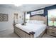 A primary bedroom with a king-size bed, ceiling fan, and an ensuite bathroom at 4368 River Birch Bnd, Lakeland, FL 33811