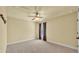 Simple bedroom featuring neutral walls, plush carpet, and a ceiling fan at 4759 Lathloa Loop, Lakeland, FL 33811