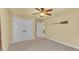 Comfortable bedroom with neutral walls, ceiling fan, carpet, and a closet at 4759 Lathloa Loop, Lakeland, FL 33811