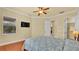 Bedroom featuring hardwood floors, a flat-screen TV, and a window with neighborhood views at 4759 Lathloa Loop, Lakeland, FL 33811