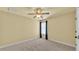 Cozy bedroom with neutral walls, plush carpet, and a ceiling fan at 4759 Lathloa Loop, Lakeland, FL 33811