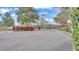 Gated entrance to community with American flag waving in background, lush landscaping, and signage at guard house at 4759 Lathloa Loop, Lakeland, FL 33811