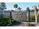 Community entrance sign for Morgan Creek Preserve with black fencing, shrubbery, and palm trees against a clear sky at 4759 Lathloa Loop, Lakeland, FL 33811