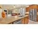 Spacious kitchen featuring stainless steel appliances, wood cabinets and granite countertops at 4759 Lathloa Loop, Lakeland, FL 33811