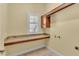 Bright laundry room with a large folding counter and storage cabinet at 4759 Lathloa Loop, Lakeland, FL 33811