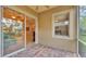 Outdoor patio with brick pavers, leading to an interior space with large windows and natural light at 4759 Lathloa Loop, Lakeland, FL 33811