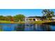 View of the community pond with a water fountain, playground, and clubhouse nearby at 4759 Lathloa Loop, Lakeland, FL 33811