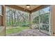 Charming screened porch with brick flooring and a serene view of the lush backyard at 4759 Lathloa Loop, Lakeland, FL 33811