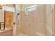 Glass-enclosed shower features neutral tile, a shower bench, and a sleek shower head at 4759 Lathloa Loop, Lakeland, FL 33811