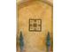 Elegant interior wall featuring decorative art, a textured finish, and symmetrically placed topiary plants at 4759 Lathloa Loop, Lakeland, FL 33811
