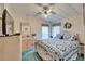 Comfortable bedroom with a ceiling fan, floral wallpaper, ample sunlight, and blue bedding at 4985 Deerwood Dr, Lakeland, FL 33810